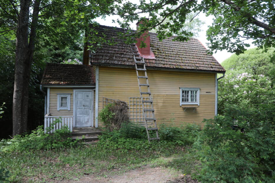 Keltainen Aattolan rakennus kesäisessä maisemassa
